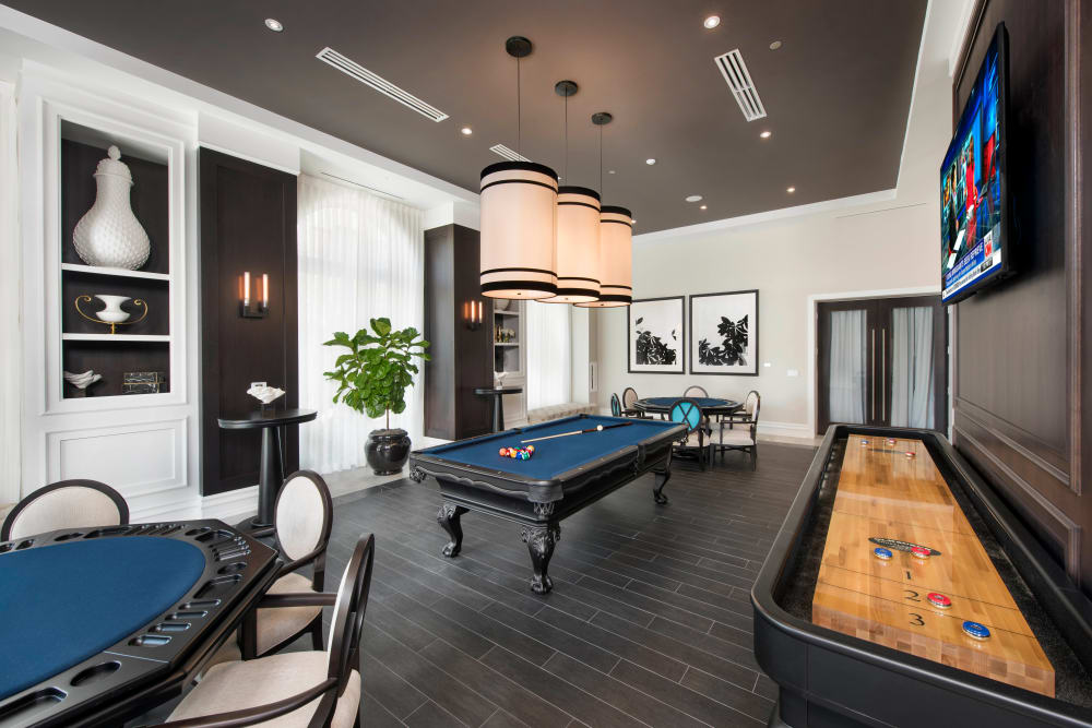 Game room with tabletop shuffleboard, billiards, and more in the clubhouse at Olympus Harbour Island in Tampa, Florida