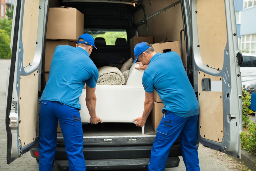 Movers removing a couch from a moving truck into storage at Storage Units in Augusta, Georgia