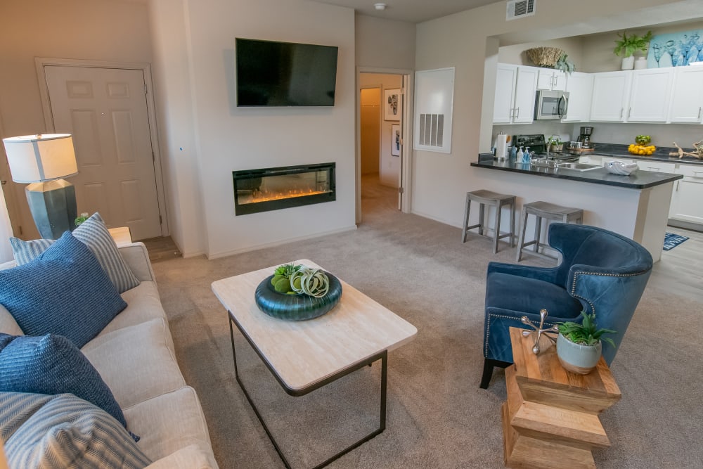 Stunning living room with plush carpet at Bend at New Road Apartments in Waco, Texas