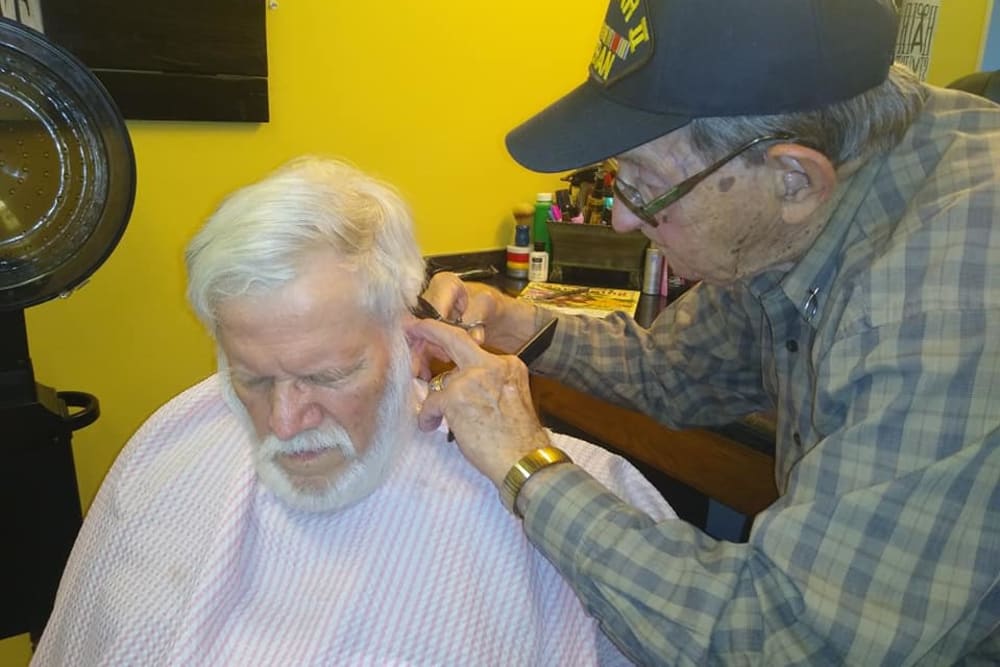 Resident giving a hair cut in the salon at Willow Creek Senior Living in Elizabethtown, Kentucky.