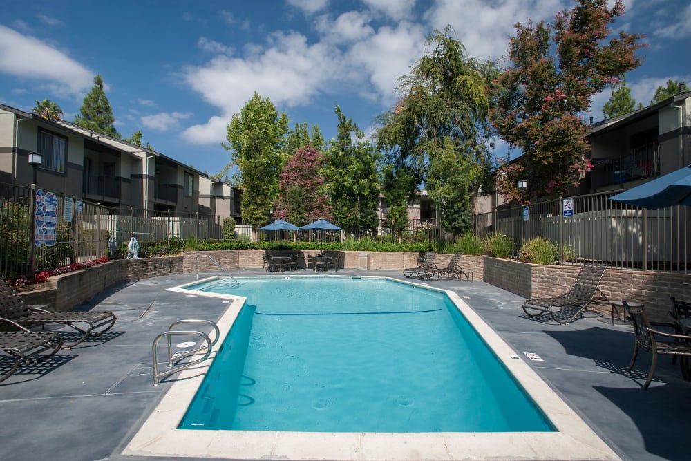 Resort-style swimming pool with a sundeck at Valley Ridge Apartment Homes in Martinez, California