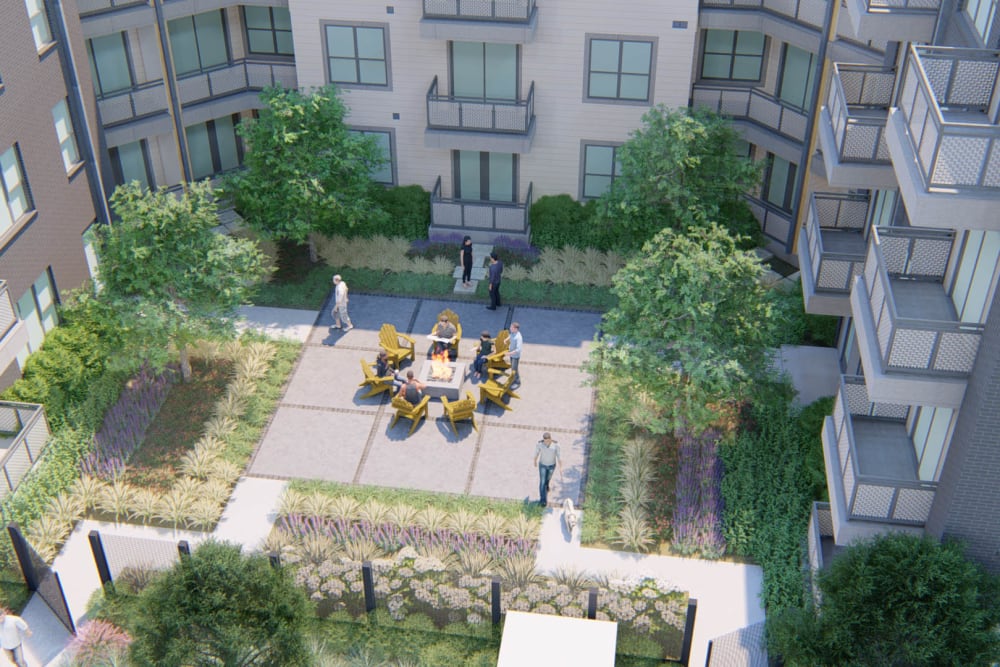 Aerial rendering of the fire pit area surrounded by mature trees in the courtyard at Olympus on Broadway in Carrollton, Texas