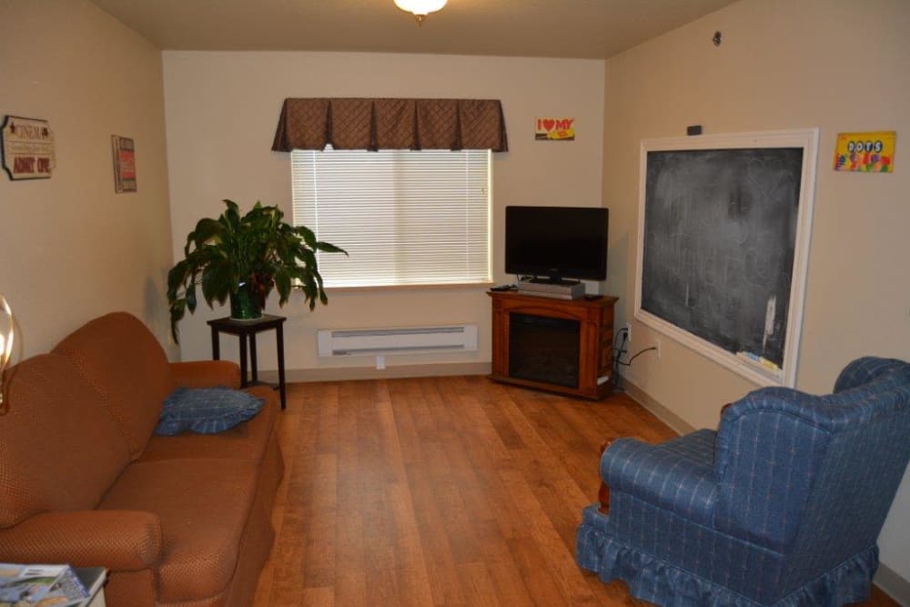 Cozy resident living room in assisted living apartment at Courtyard Estates at Hawthorne Crossing in Bondurant, Iowa.