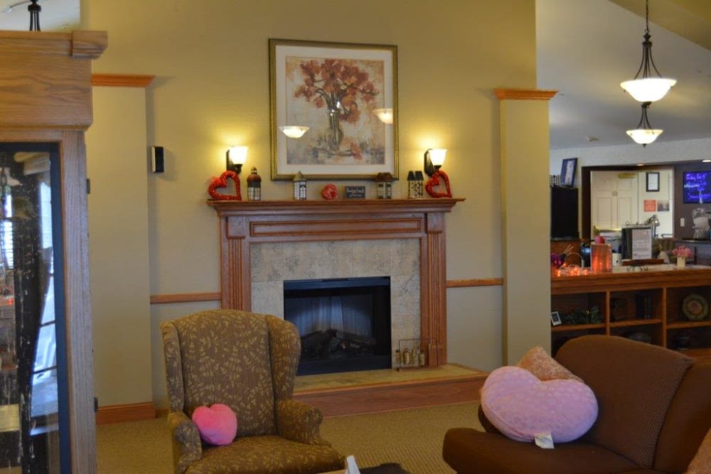 Bright seating nook near fireplace at Courtyard Estates at Hawthorne Crossing in Bondurant, Iowa.