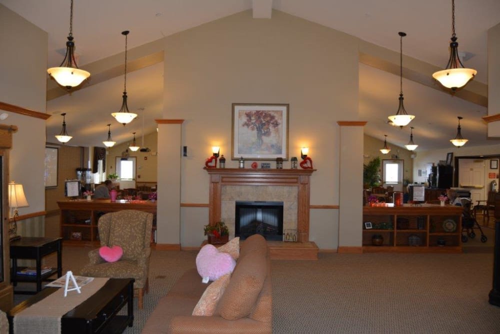 Main lobby features a fireplace and comfortable seating at Courtyard Estates at Hawthorne Crossing in Bondurant, Iowa