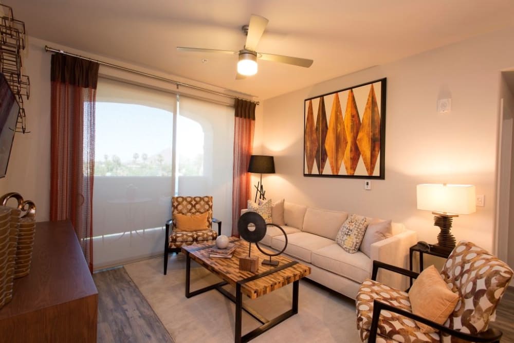 Spacious living room with a ceiling fan at Luxe Scottsdale Apartments in Scottsdale, Arizona