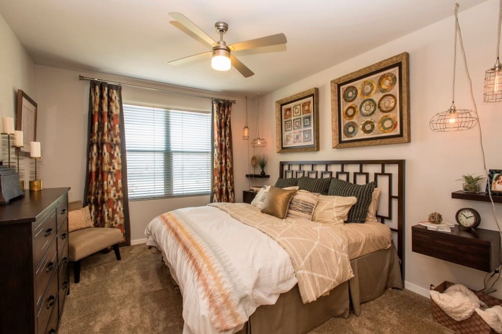 Bedroom with a ceiling fan at Luxe Scottsdale Apartments in Scottsdale, Arizona