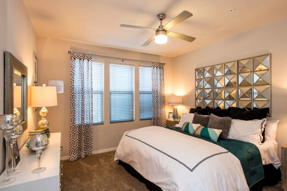 Bright master bedroom with plush carpet at Luxe Scottsdale Apartments in Scottsdale, Arizona