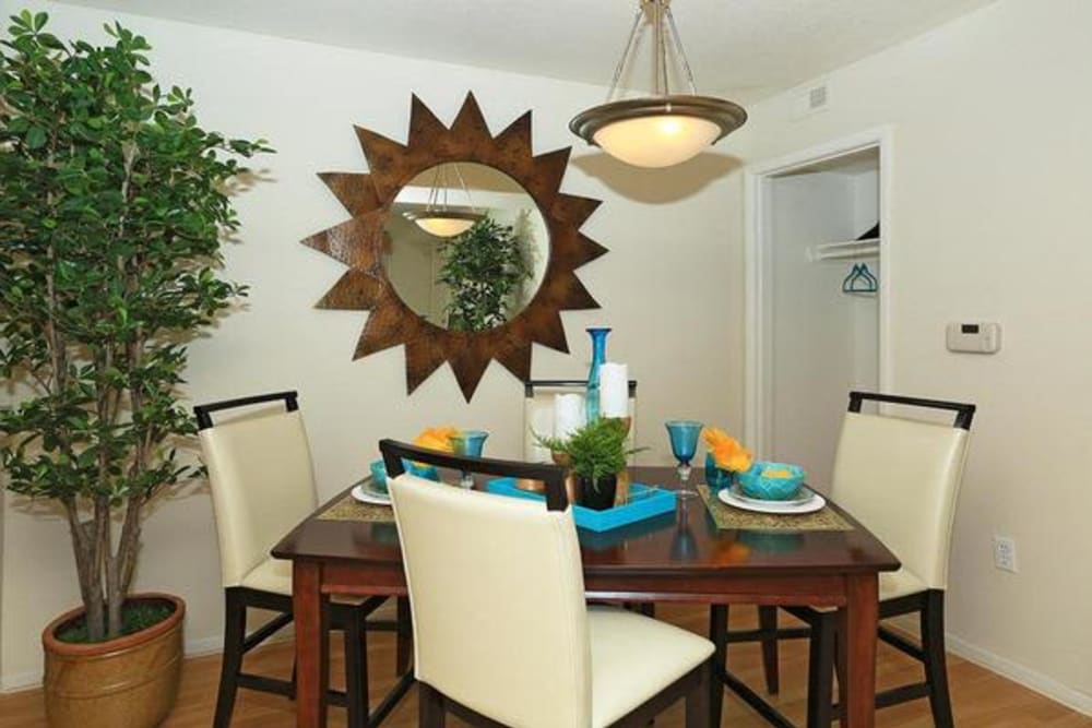 Dining area with a custom chandelier in a model home at Alterra Apartments in Las Vegas, Nevada