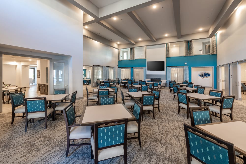 Giant dining hall with high ceilings and a large tv at The Luxe at Cedar Hill in Cedar Hill, Texas