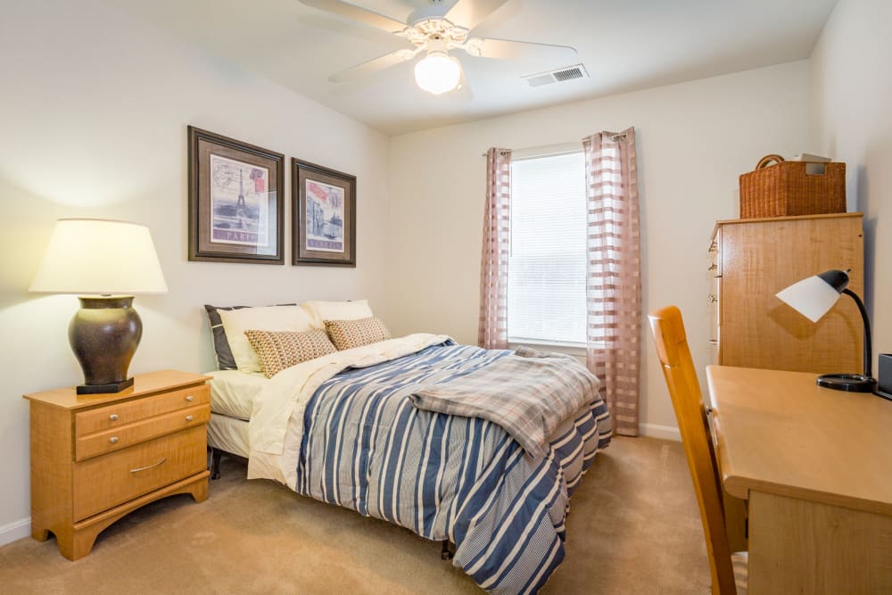 Comfortable model bedroom and large window at Belmont Landing in Farmville, Virginia