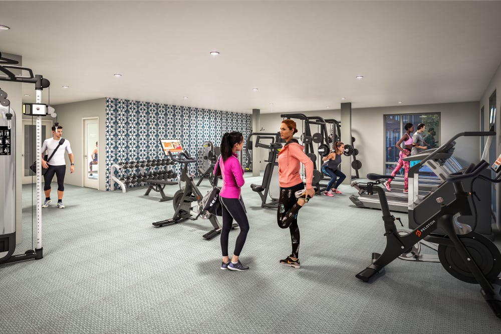 Residents checking out the fitness center at UNCOMMON Raleigh in Raleigh, North Carolina