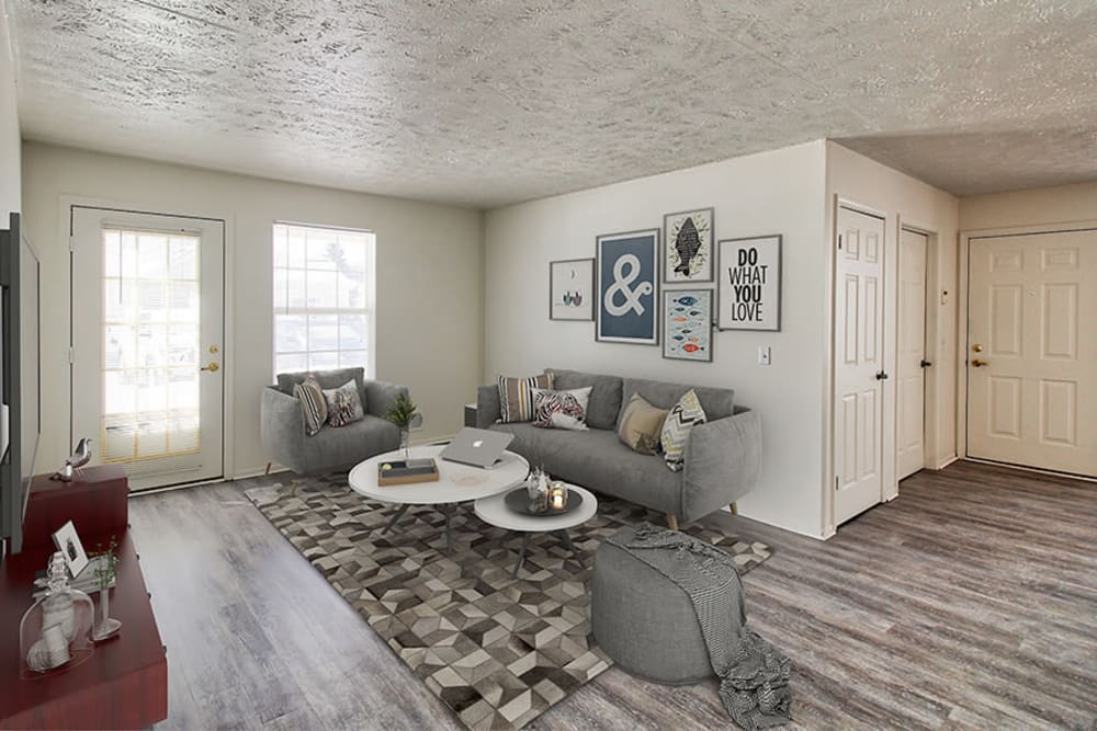 Spacious model living room with plank flooring at Westview Commons Apartments in Rochester, New York