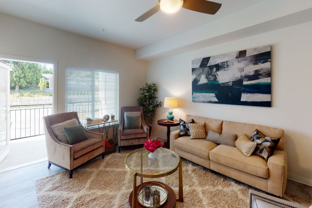 Well decorated model living room with patio access at LARC at Burien in Burien, Washington