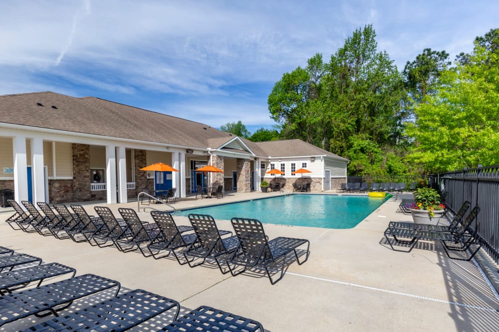 Pool lounge chairs at Sunchase Apartments in Greenville, North Carolina