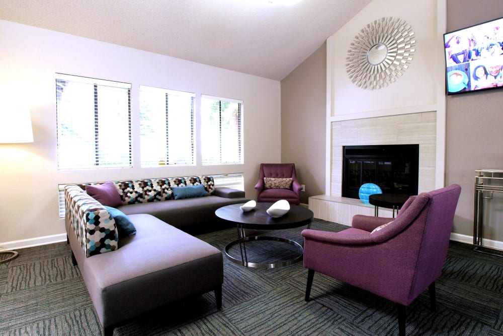 Clubhouse with comfortable seating and a fireplace at Plum Tree Apartment Homes in Martinez, California