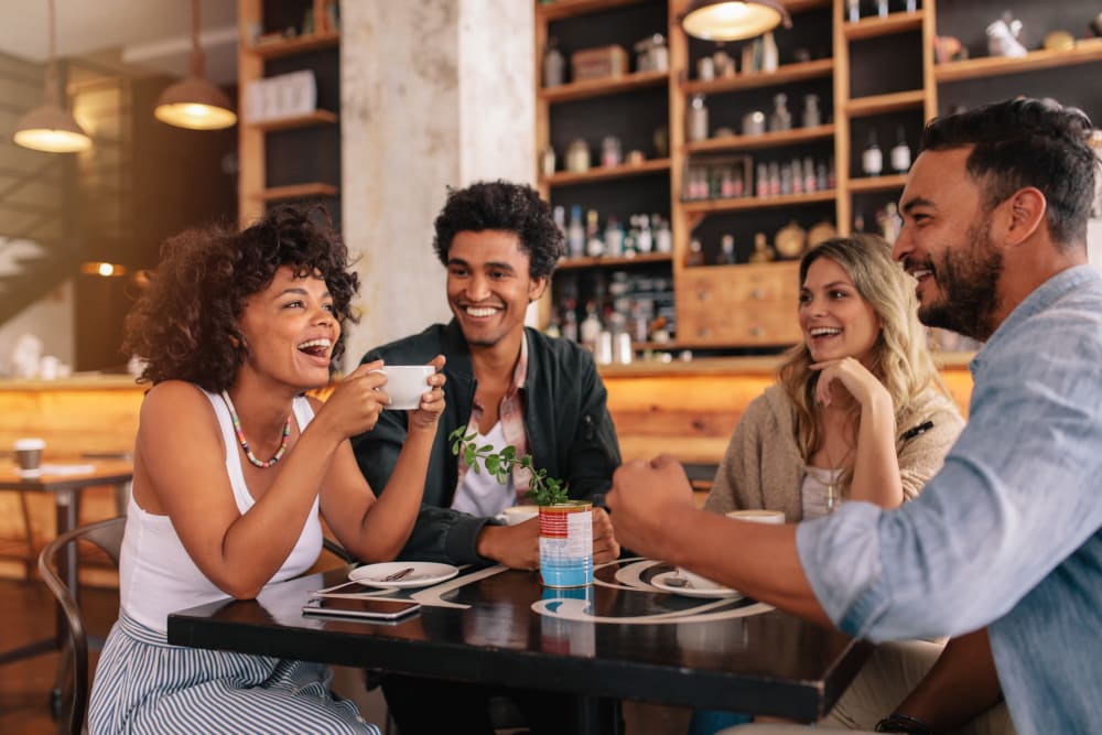 Friends enjoying lunch at a local restaurant near Bend at New Road Apartments in Waco, Texas