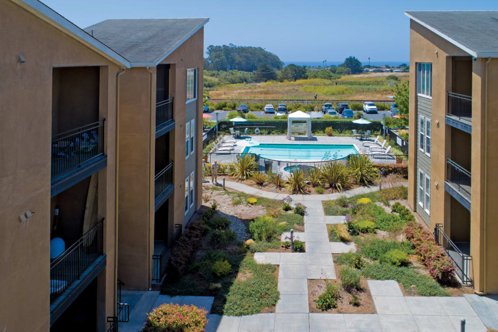 View of community pool and beautiful resort style grounds at Pacific Shores