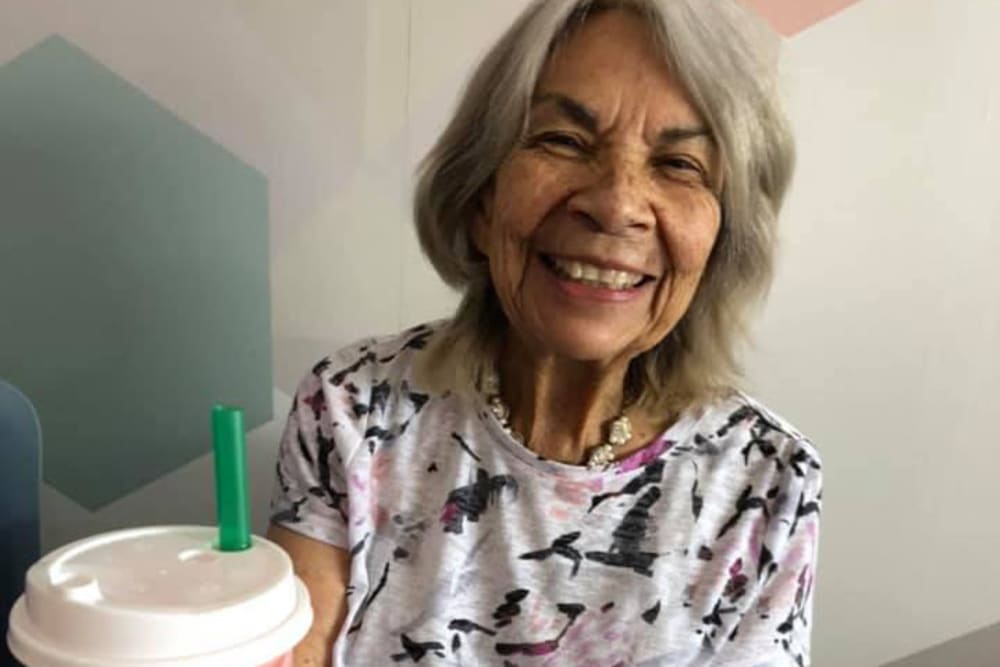 smiling senior resident with coffee