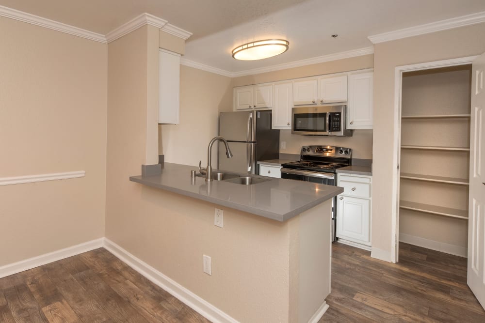 Kitchen with a breakfast bar at Sterling Heights Apartment Homes in Benicia, California