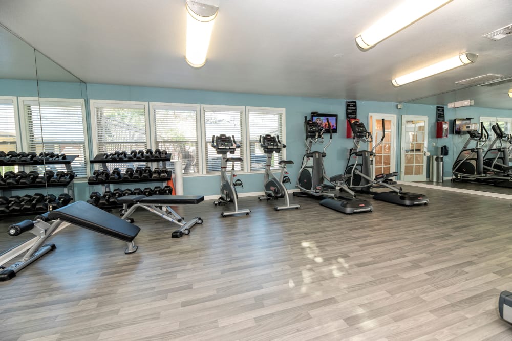Fitness center with a flat-screen TV at Sterling Heights Apartment Homes in Benicia, California