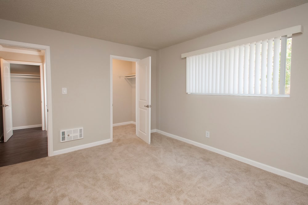 Master bedroom with a walk-in closet at Regency Plaza Apartment Homes in Martinez, California