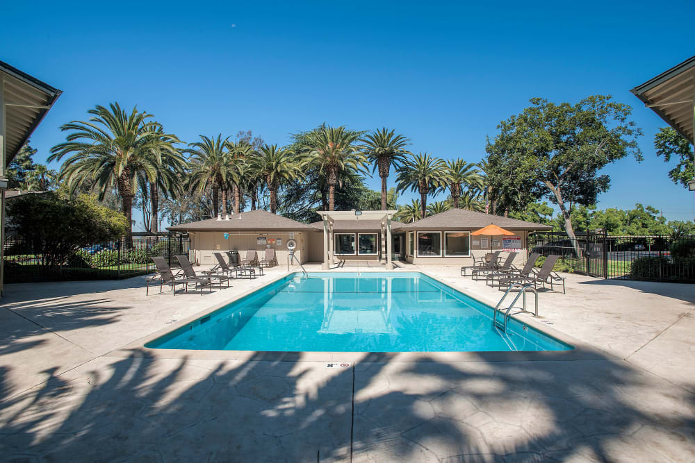 The bright blue swimming pool at Villa Palms Apartment Homes in Livermore, California