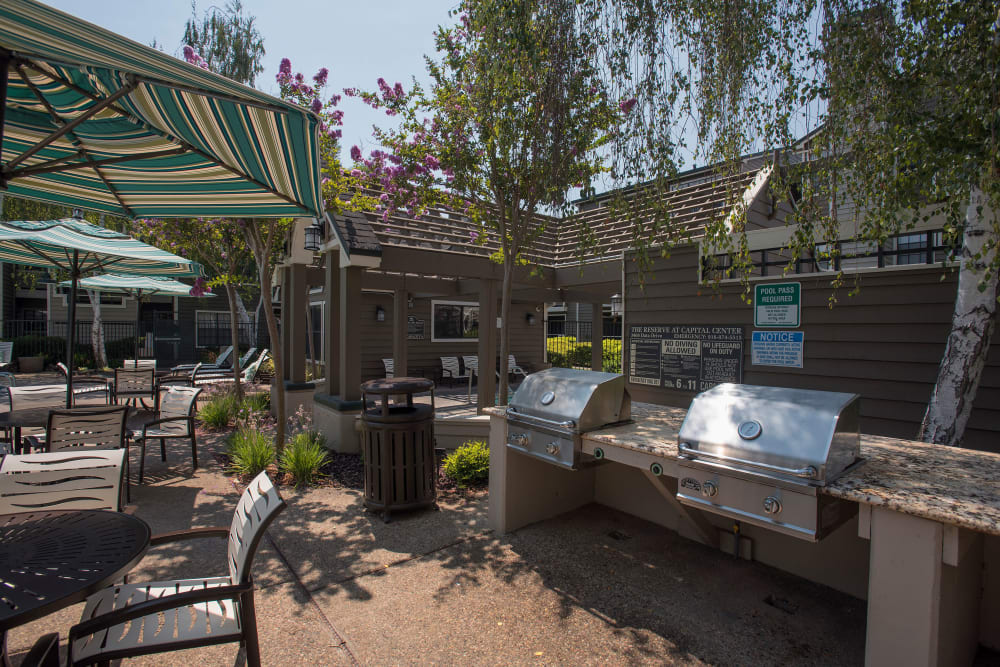 Grilling stations with seating for summer picnics at The Reserve at Capital Center Apartment Homes in Rancho Cordova, California