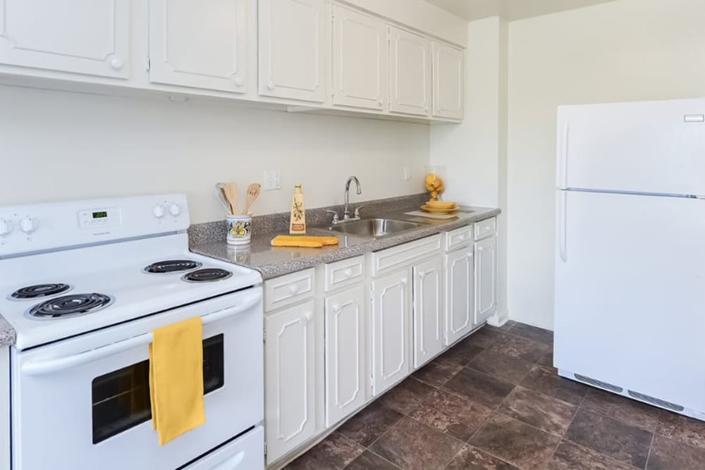 Kitchen with white cabinetry and appliances at Lexington House Apartment Homes in Cherry Hill, New Jersey