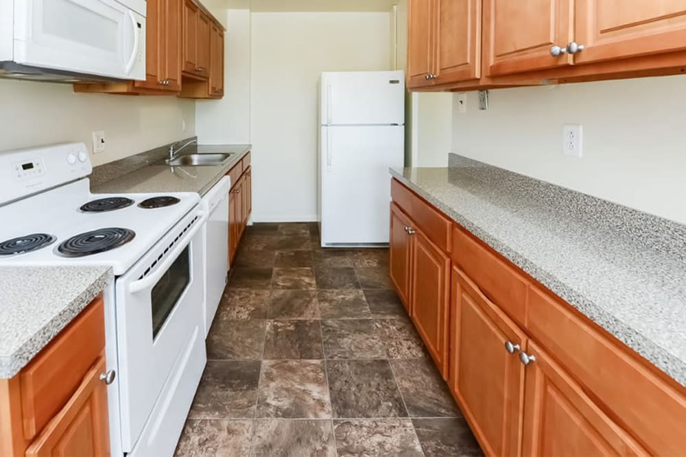 Kitchen with maple cabinets and a full appliance package at Lexington House Apartment Homes in Cherry Hill, New Jersey