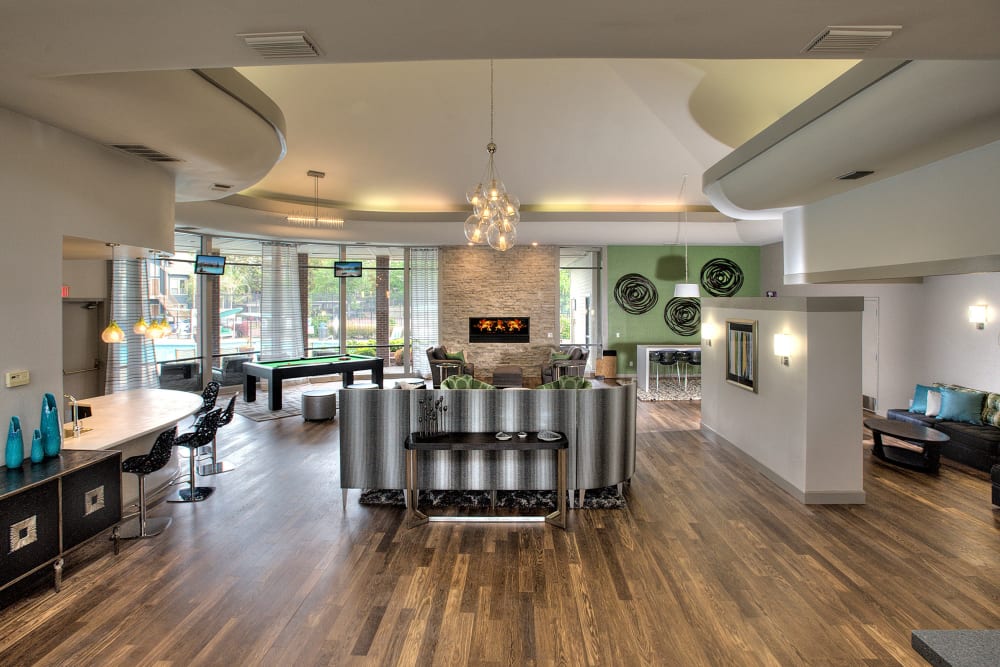 Inside of the relaxing clubhouse with hardwood-style flooring at Deer Valley Apartment Homes in Roseville, California