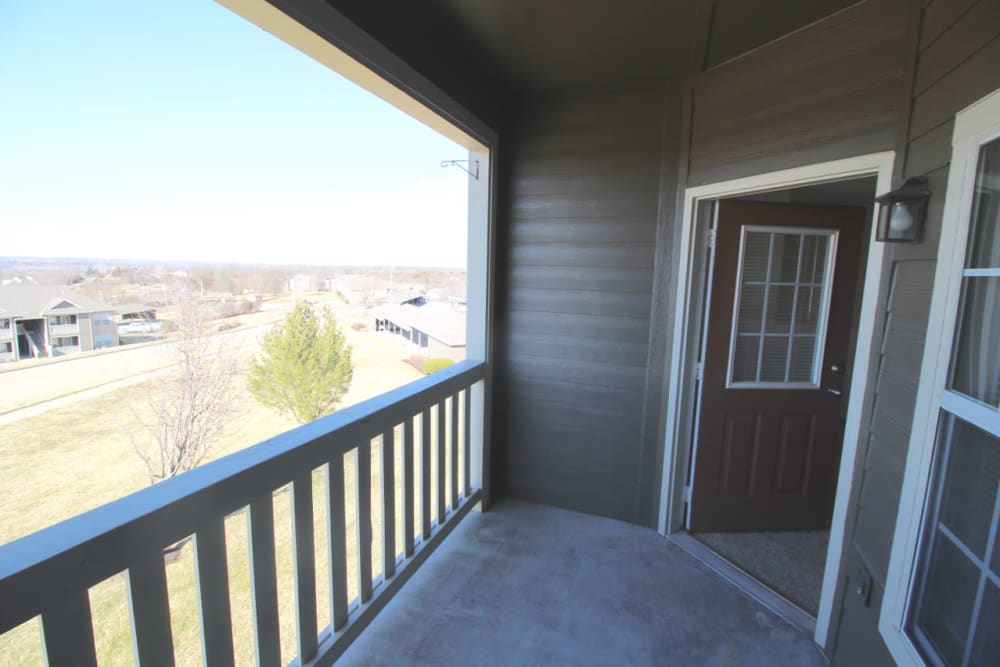 Private balcony with a view outside a model home at Timber Lakes Apartment Homes in Kansas City, Missouri