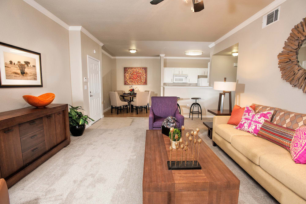 Living room with plush carpeting and a ceiling fan at River Oaks Apartment Homes in Vacaville, California