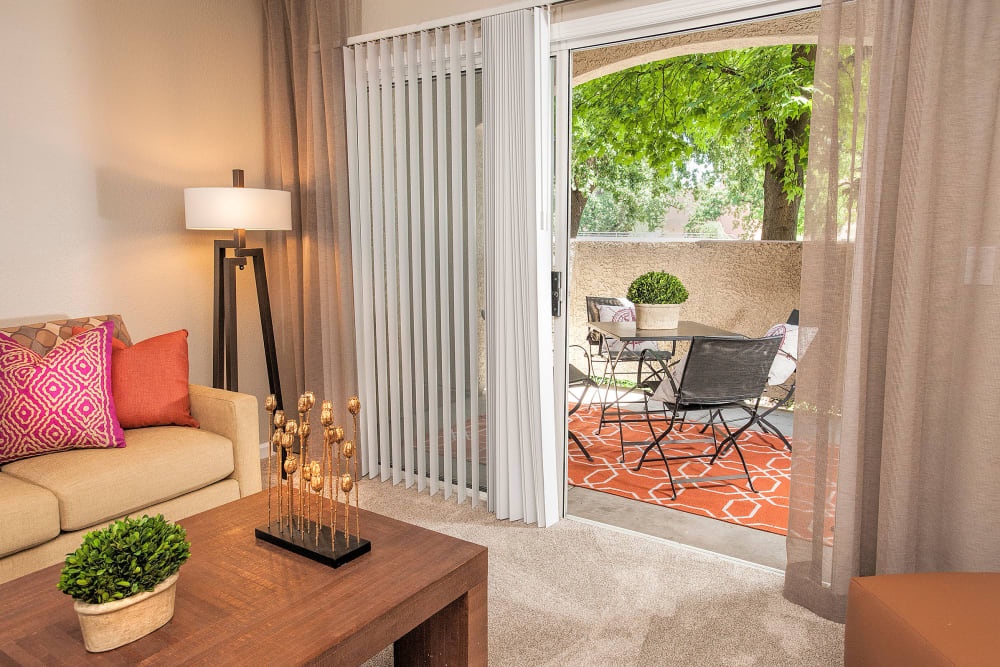 Living room with a private patio at River Oaks Apartment Homes in Vacaville, California