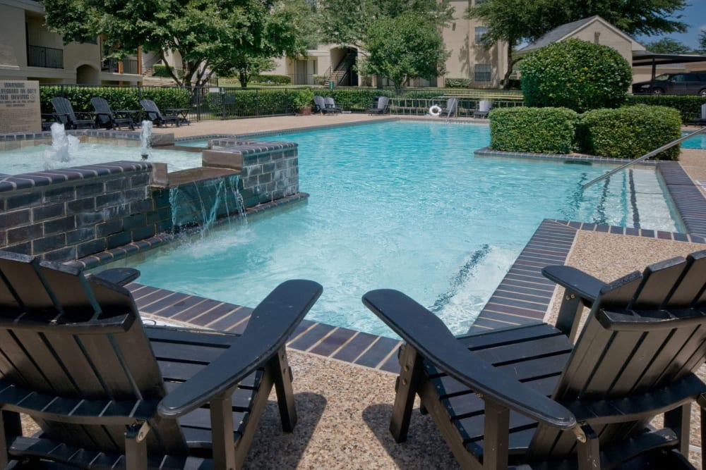 Lounge chairs near the pool at Rockbrook Creek in Lewisville, Texas