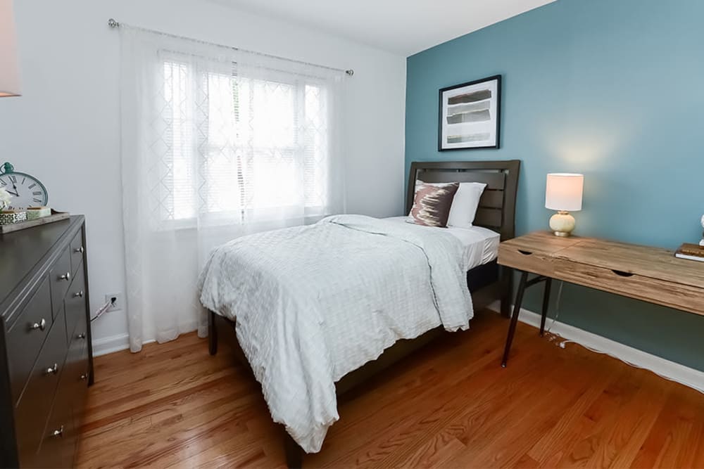 Cozy bedroom with great natural light at Elmwood Village Apartments & Townhomes in Elmwood Park, New Jersey