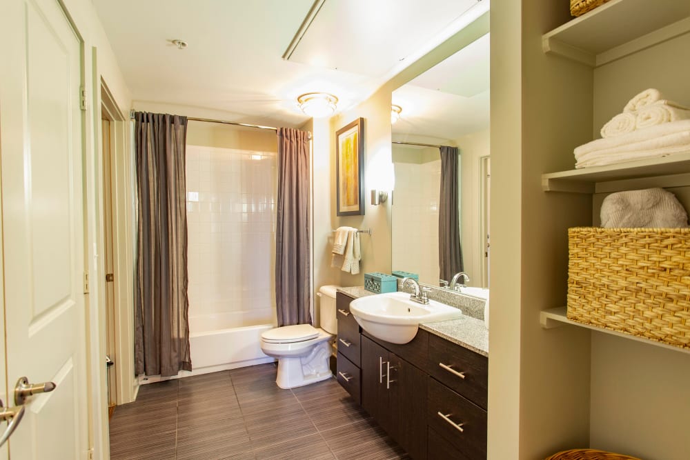 Spacious master bathroom with extra storage in a model apartment at Olympus Midtown in Nashville, Tennessee