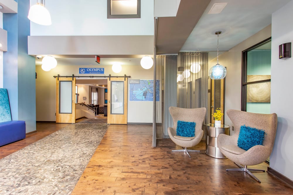 Welcoming lobby interior with comfortable places to relax at Olympus Midtown in Nashville, Tennessee