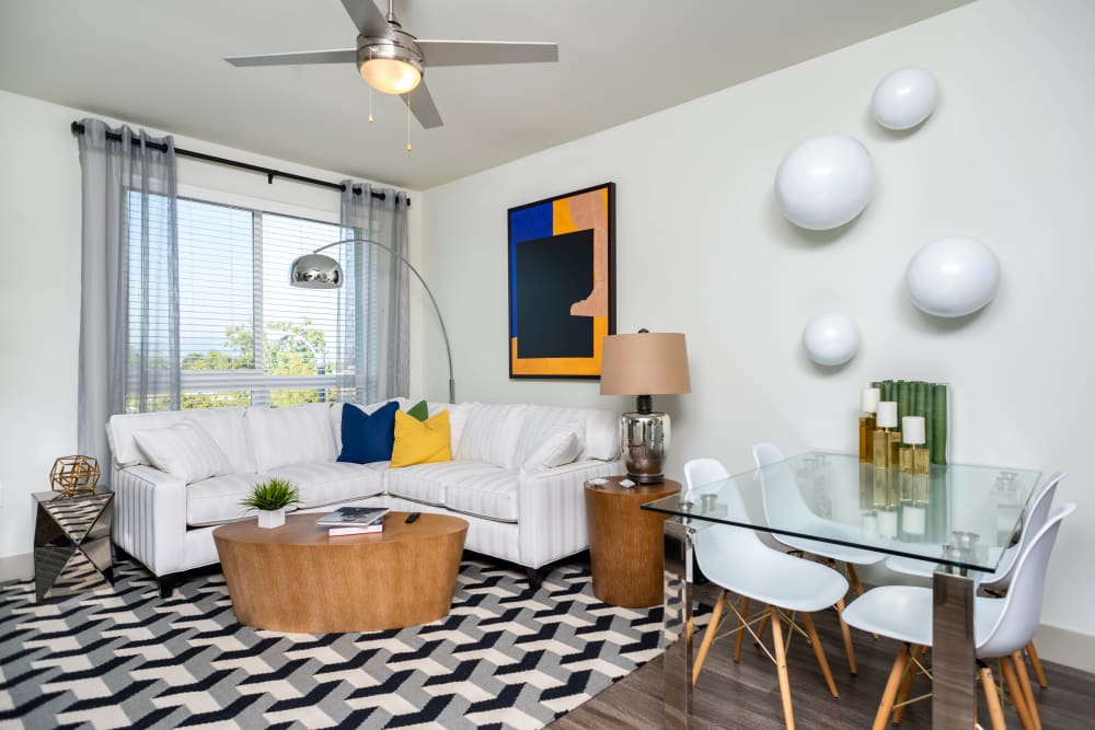 Modern furnishings and a ceiling fan in a model apartment's living area at Fusion Apartments in Irvine, California