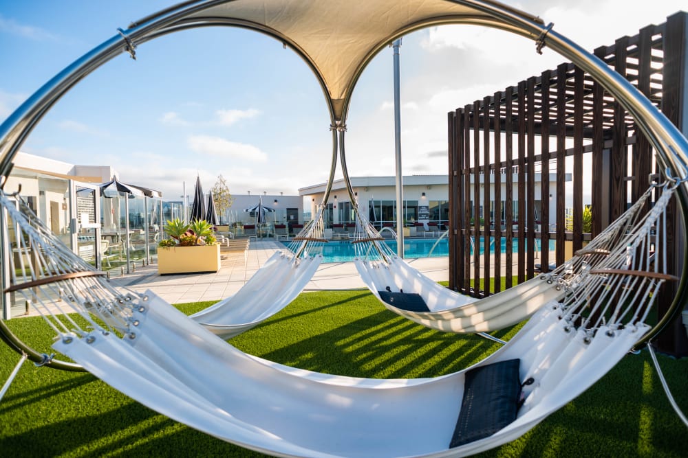 Hammocks near the pool on the rooftop at Fusion Apartments in Irvine, California