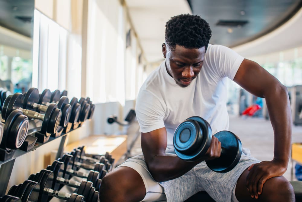 Resident lifting weights at Sugarberry Apartments in Tulsa, Oklahoma
