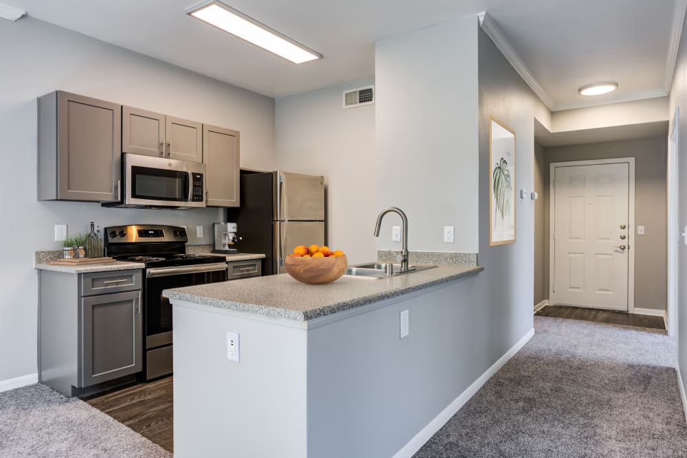 Renovated kitchen with grey cabinetry at Miramonte and Trovas in Sacramento, California