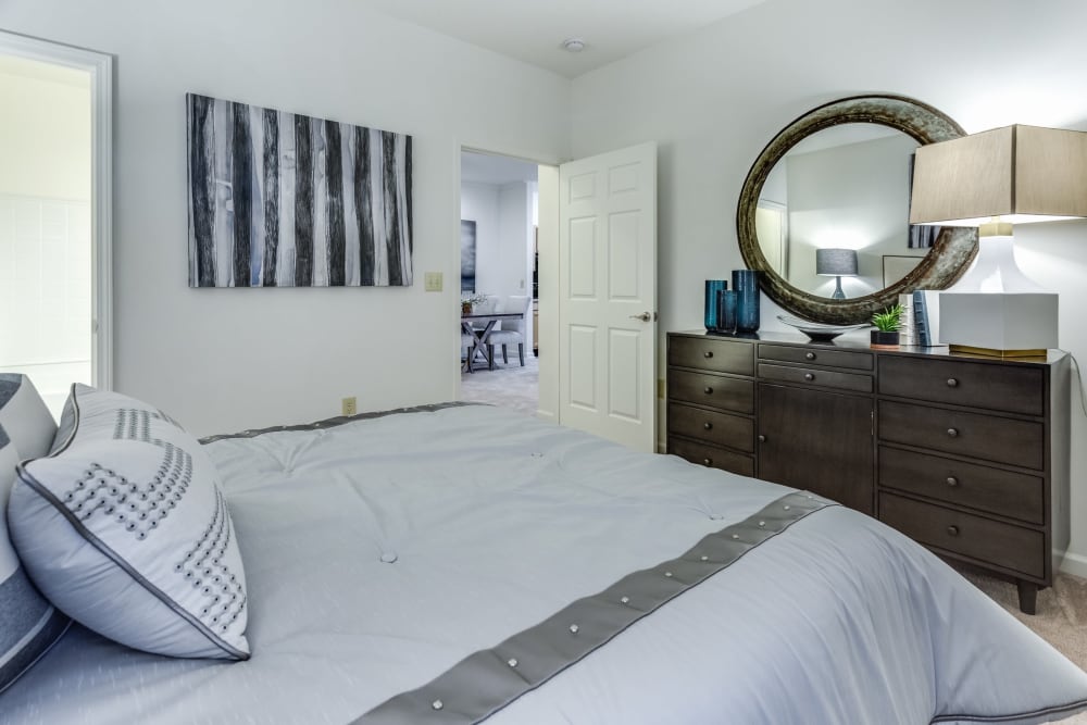 A bed and a dresser at The Enclave at Deep River in Greensboro, North Carolina