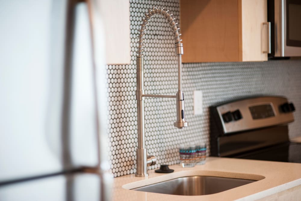 Custom tile backsplash and modern fixtures in a model home's kitchen at Brooklyn Yard in Portland, Oregon