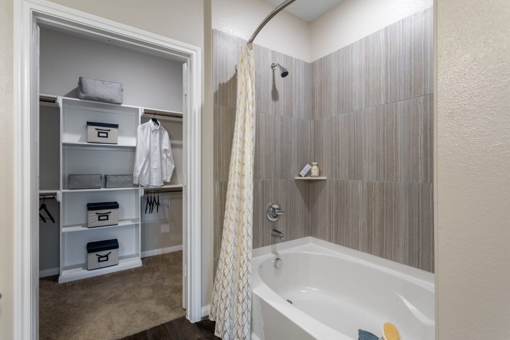 Bathroom with a connected walk-in closet at The Abbey at Sonterra in San Antonio, Texas