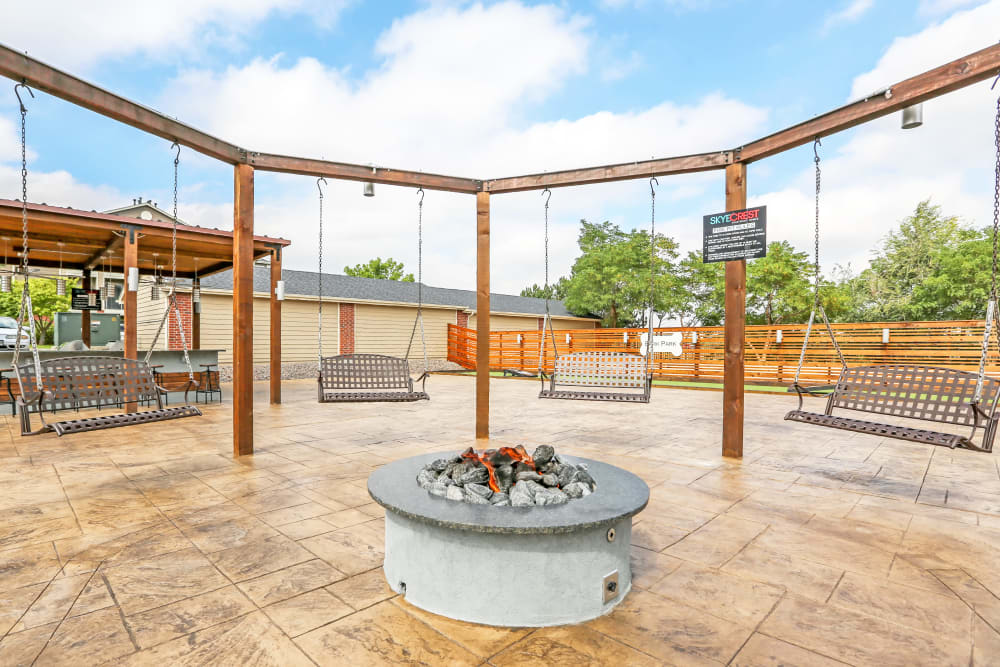 Swinging seats near the fire pit at Skyecrest Apartments in Lakewood, Colorado