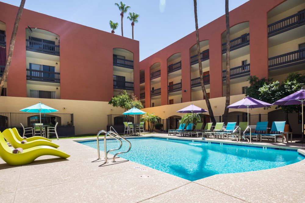 Luxury swimming pool with apartment building in background at 4127 Arcadia in Phoenix, Arizona