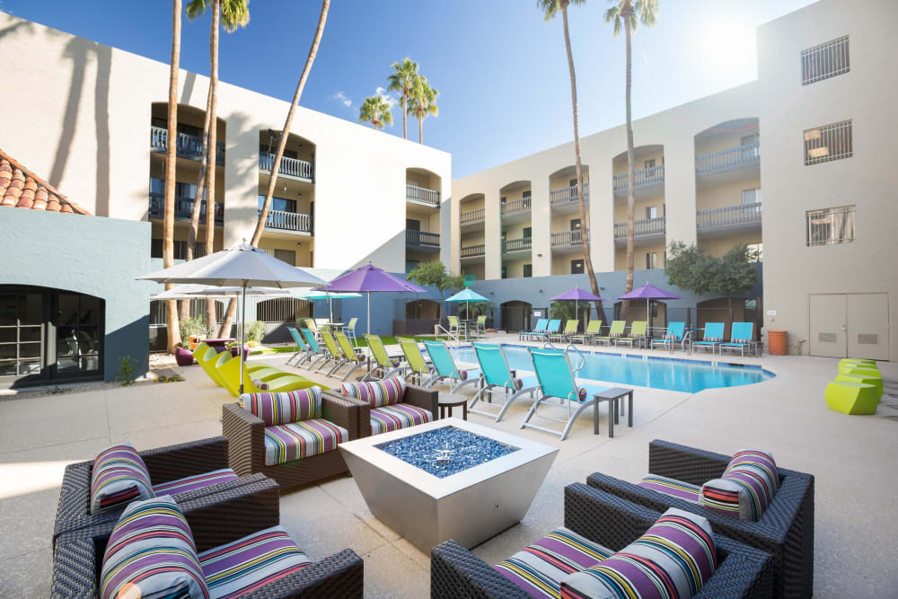 Large outdoor seating area poolside with building exterior in the background at 4127 Arcadia in Phoenix, Arizona