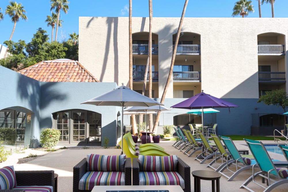 Poolside lounge chairs and a couch she did by large umbrella at 4127 Arcadia in Phoenix, Arizona