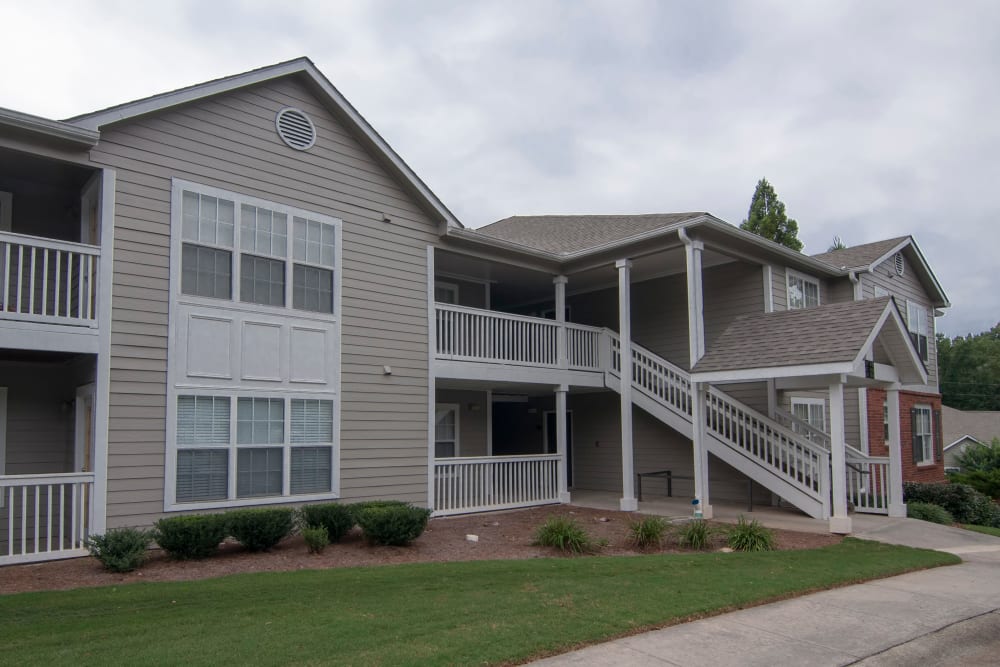 Building exterior with grassy lawn at Bellingham Apartment Homes in Marietta, Georgia